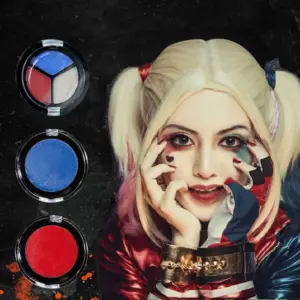 A child wearing Halloween face paint depicting a spooky pumpkin.