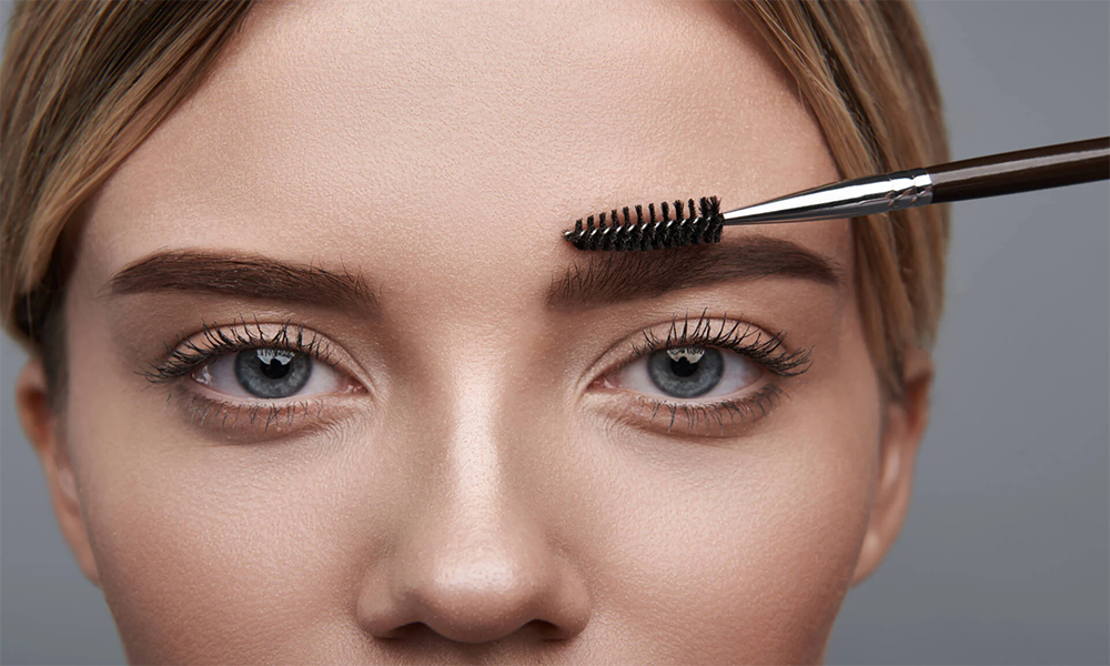 A close-up image showing precise application of color cosmetic, enhancing the brow shape and definition.