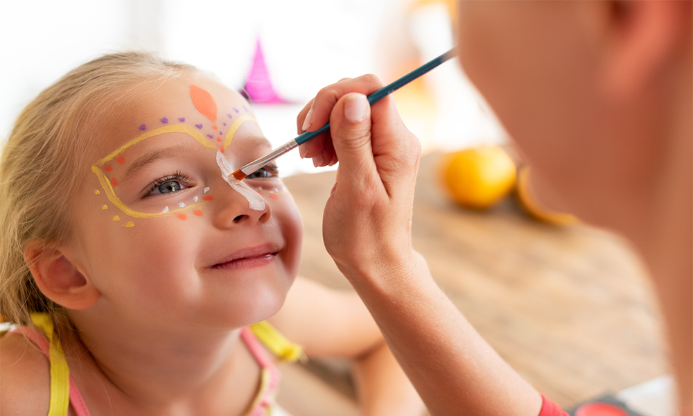 Kids enjoying vibrant face paint designs at a birthday party.