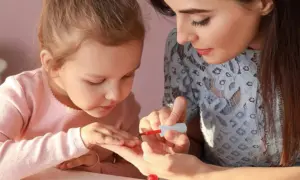 Nail artist showcasing intricate and creative designs using kids makeup.