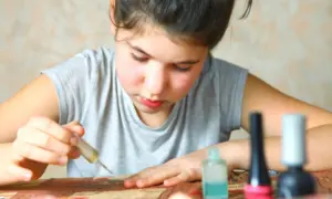 Colorful kids makeup bottles arranged in a row on a white background.