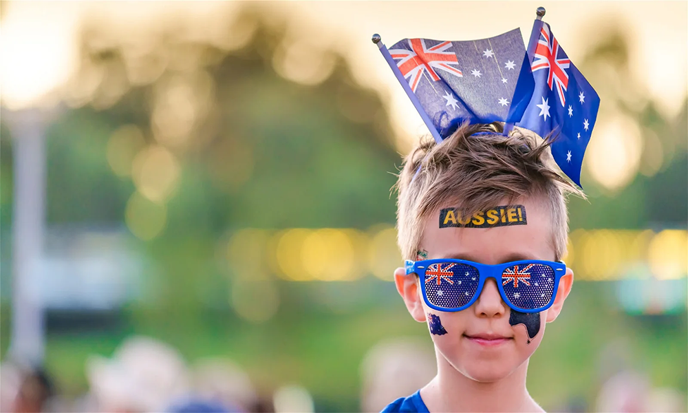 Excited fans showing off their creative sport face paint designs at the stadium.