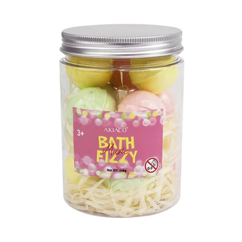 Children smiling while playing with bath bombs in a bathtub filled with colorful water.