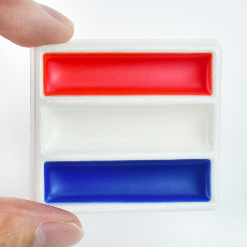Fan applying face paint for sports before a game.