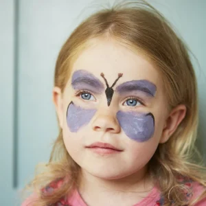 Children's faces painted with vibrant colors and creative designs using safe, non-toxic face paints.