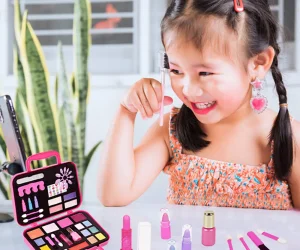 Young Girl Playing with Children Makeup.
