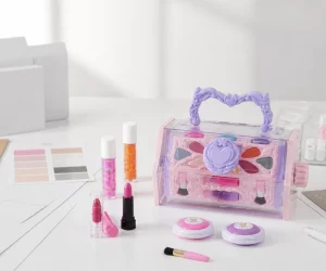 White-label kids makeup case and cosmetic components arranged on a product development table with packaging mockups.